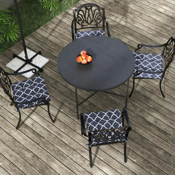 Navy blue seat cushion pillows with white geometric trellis pattern and tie straps on chairs