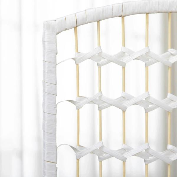 Close-up of white woven lattice panel on a folding room divider privacy screen