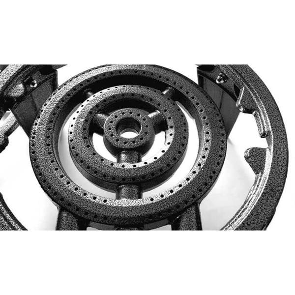Close-up of a gas stove burner on a white background