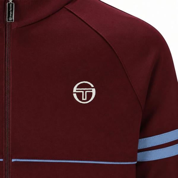 Fig and country blue Sergio Tacchini Orion track top featuring a white logo, zip-up collar, and striped sleeve detailing.