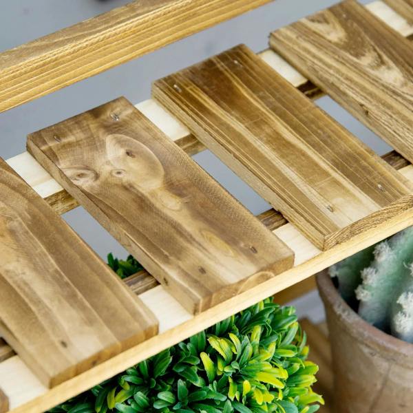 Wooden slatted shelves on three-tier plant stand, showing rail joints and planter tops.