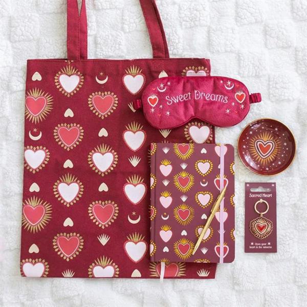 Sacred Heart keyring charm on a hanging display card with heart motif