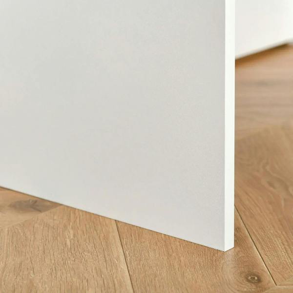 White desk leg and bottom edge detail with clean, straight alignment