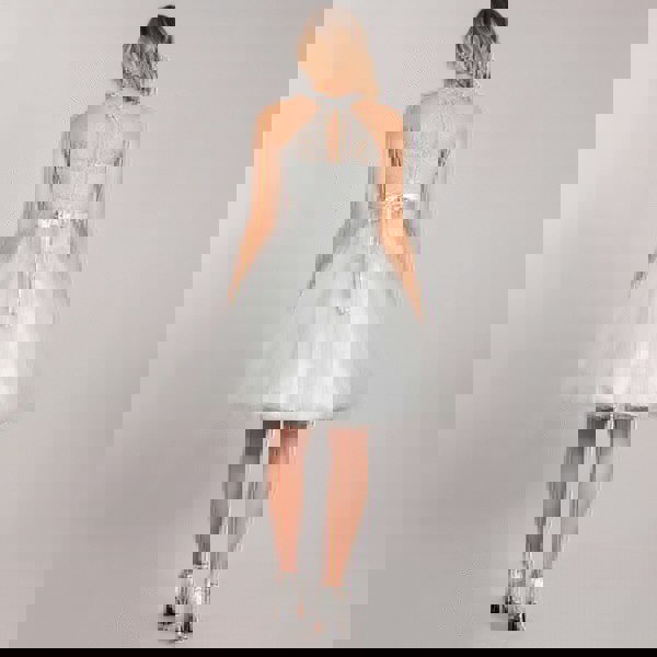 teenage model wearing a beaded halter neck dress from uk flower girl boutique