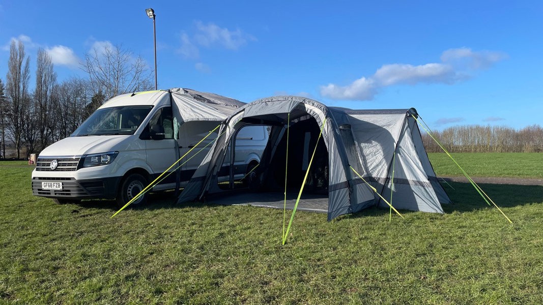 The Cocoon Breeze® XL v2 Motorhome Awning (Grey) from OLPRO pictured in a campsite attached to a VW Crafter Camper Van