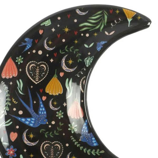 Crescent moon trinket dish, close view of colorful bird and crescent motifs on dark base.