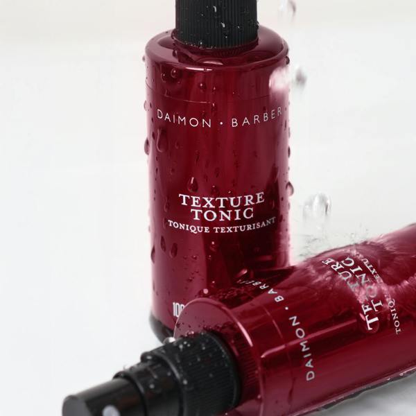 Two Texture Tonic Bottles with water running down on white background