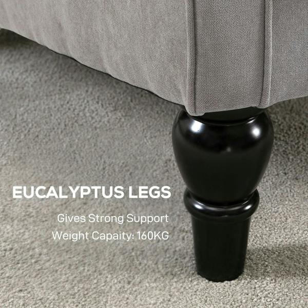 Close-up of black turned chair legs under a light grey armchair