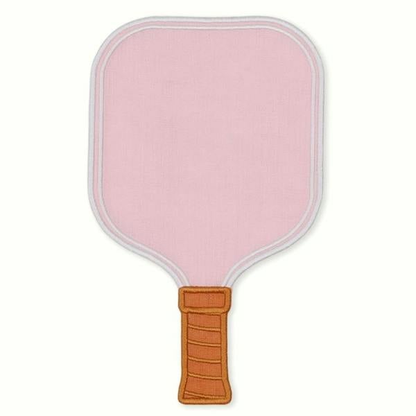 A single light pink linen cocktail napkin shaped like a pickleball paddle, detailed with a white embroidered border and a light brown stitched handle grip.