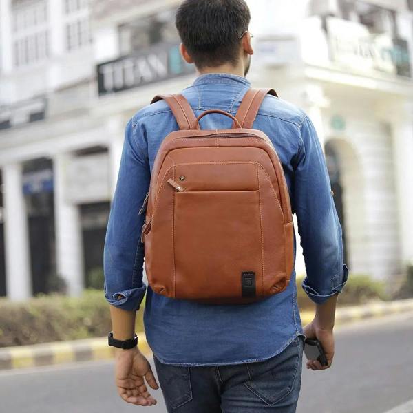 Person wearing Tan leather backpack Morgan Tuscan Bag