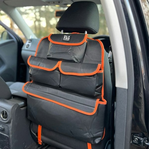 The Rear Single Seat Storage Organiser in Orange by OLPRO attached to the front drivers seat of a VW vehicle.