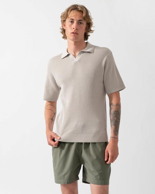 Model wearing a BOSS Orange Aravolo Mens Short Sleeve Knit Polo Shirt in Open Grey 070