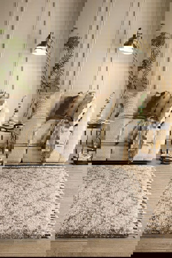 Cozy living room featuring a Moroccan-style rug in soft beige, complemented by a plush sofa and stylish decor.