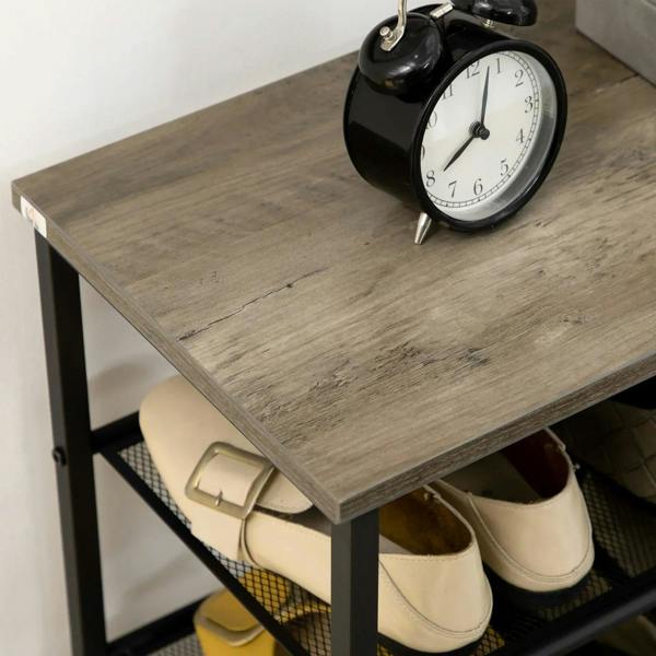 Black shoe rack top shelf with two pairs of shoes under mesh
