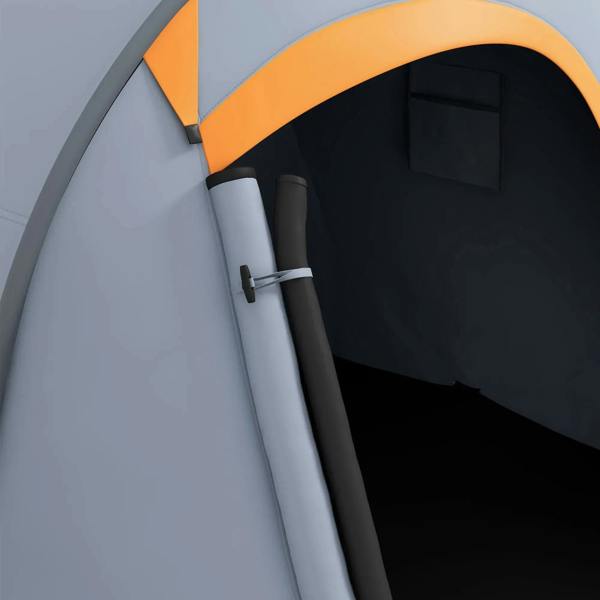 Close-up of grey tent door frame with orange front trim and dark interior