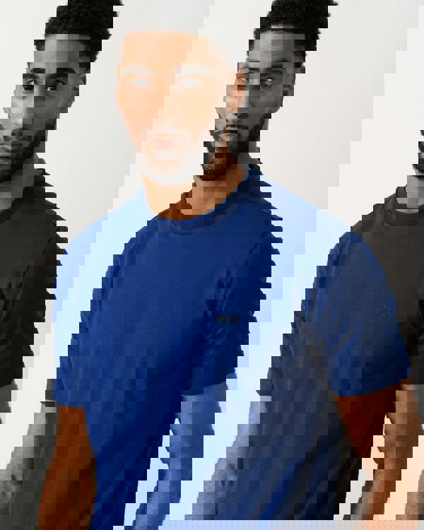detail shot of a model wearing a BOSS Green Tee Mens Stretch Cotton T-Shirt with Contrast Logo in Navy