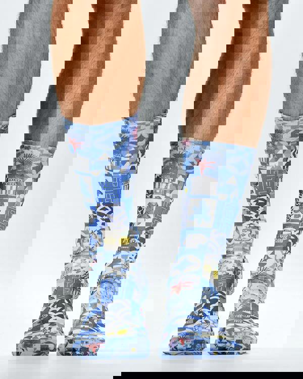 Blue patterned socks worn by a person on a white background