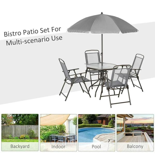 Grey outdoor dining set with umbrella and four folding chairs around round glass table