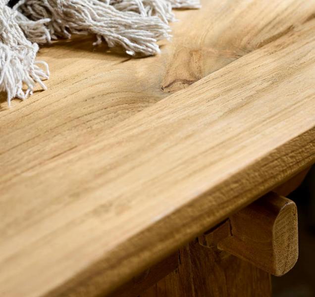 Close-up of the wood grain and live edge detail on a teak bench seat.