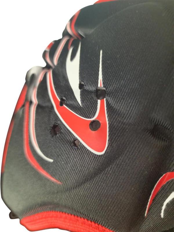 Close-up of black Origin rugby headguard ear panel with ventilation holes and red trim detail - Optimum