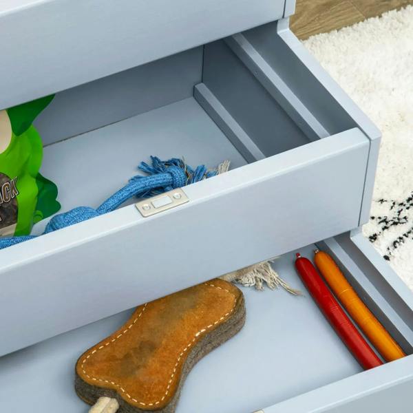 Open storage drawer inside gray pet stairs with toys and accessories