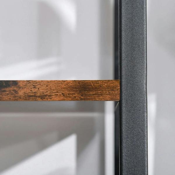 Close-up of brown wooden shelf edge with black metal leg of ladder rack.