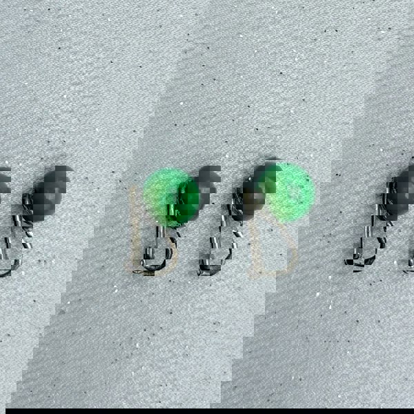 Green clip-on earrings, small round bead design, glossy green finish, silver-tone clip setting, minimalist vintage-inspired jewellery
