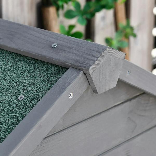 Dark grey wooden shed roof edge detail with metal fastener and cap