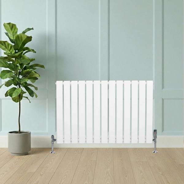 Flat single column radiator in white, 600 x 910mm, featuring sleek vertical lines, positioned beside a potted plant on a wooden floor