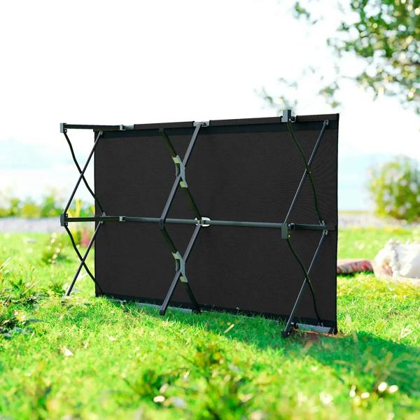 Black double camping cot folded upright with elastic straps and support legs