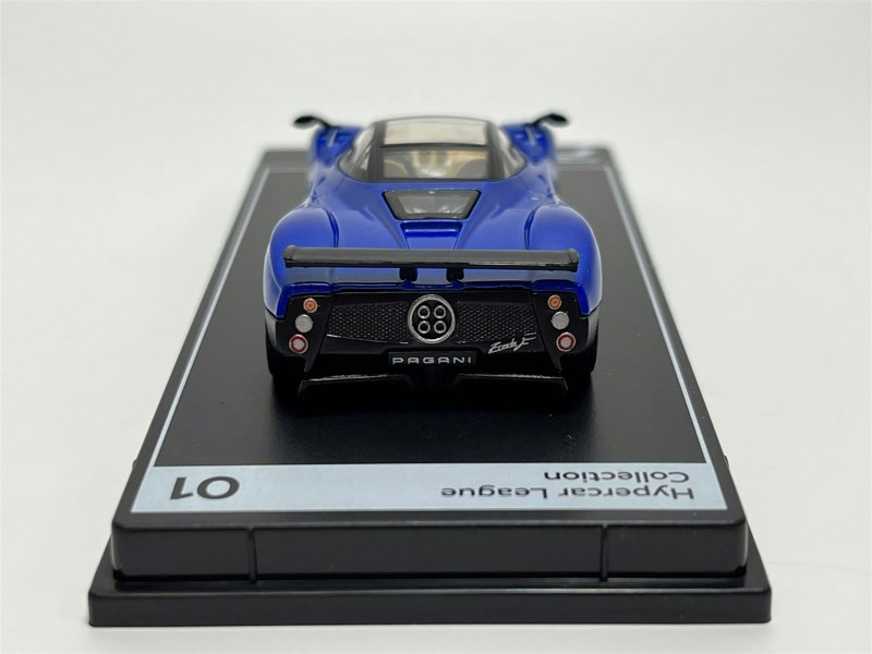 a blue toy car on a black surface
