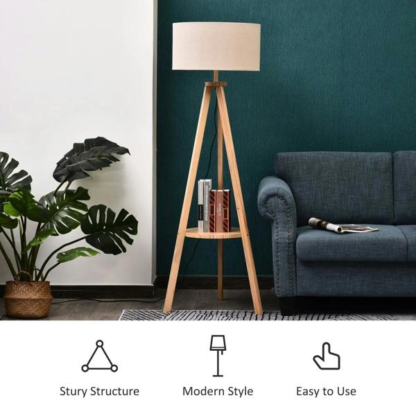 Tripod floor lamp with cream linen shade and round open shelf on wooden tripod legs
