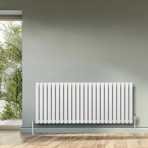White oval single column radiator with sleek vertical lines, mounted on a wall, complementing a modern interior with natural light