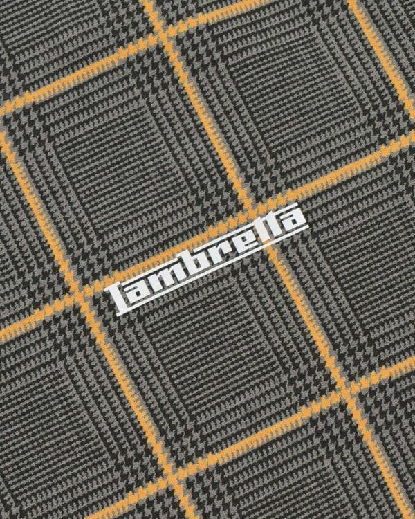Lambretta Mens Prince of Wales Check Mod Ska Casual Polo, close-up of the fabric with a classic black, gray, and yellow check pattern.