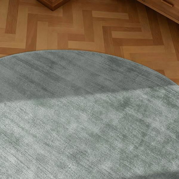 Round gray rug on a wooden floor