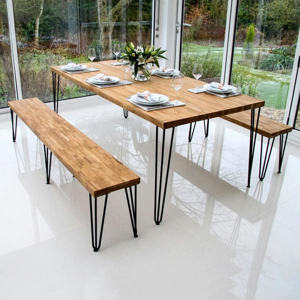 Grey 10mm hairpin leg feet protectors displayed on a modern wooden dining table with benches, enhancing stability and style