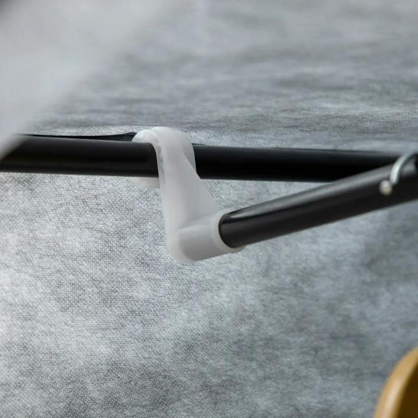 Dark grey fabric wardrobe hanging rod connection with plastic end support.