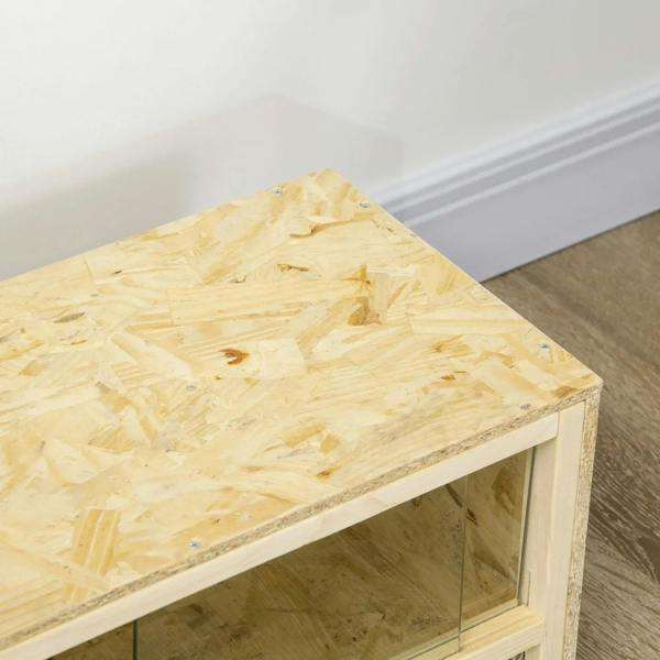 Natural wood reptile terrarium close-up with textured top and clear sliding glass panel