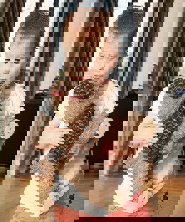 Girl hugging puppy pull toy