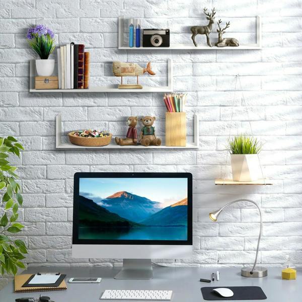 White U-shaped floating wall shelves on a brick wall with open display spaces
