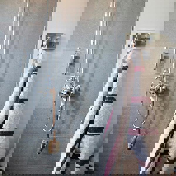 Polished chrome double towel hook on bathroom wall