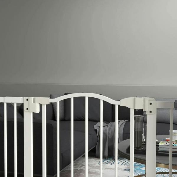 White dog safety gate with curved top rail and vertical bars, close-up view