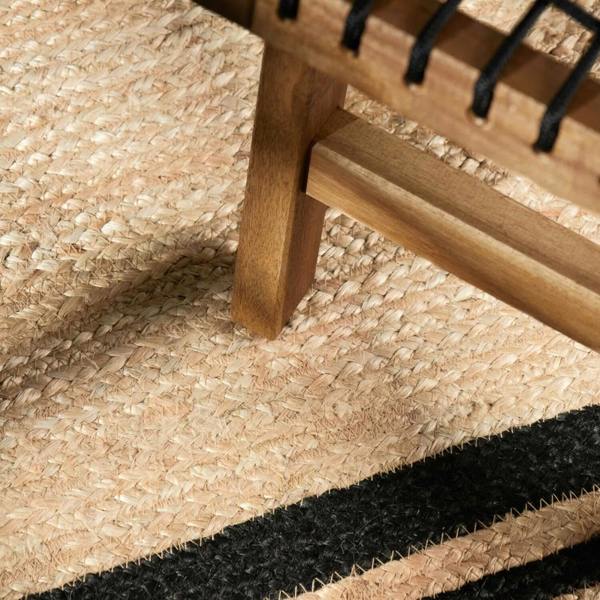 Close-up of a wooden chair with woven seat on a textured surface