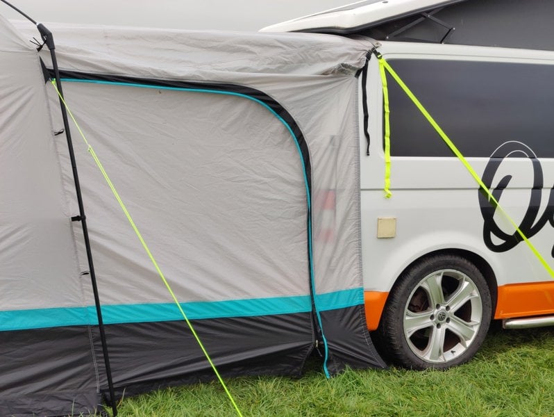 a closed tunnel door on the Snug Poled Awning, attached to a Volkswagen T5