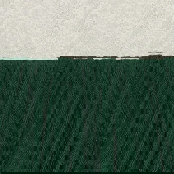 Close-up of green fabric with a textured white background