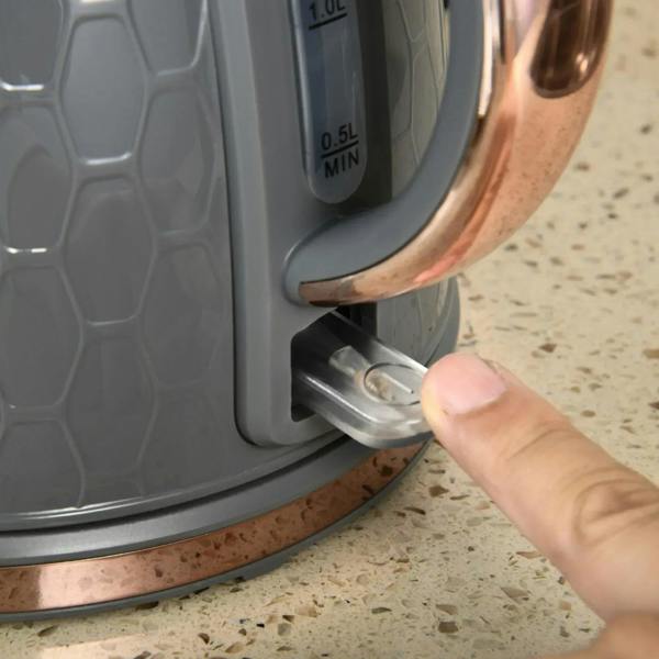 Grey electric kettle spout and water gauge area with hand filling on base