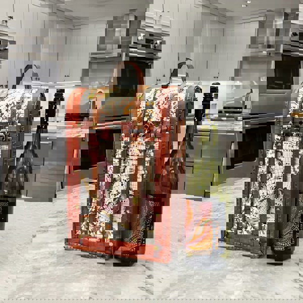 Decorative wine box with a bottle of wine on a kitchen counter