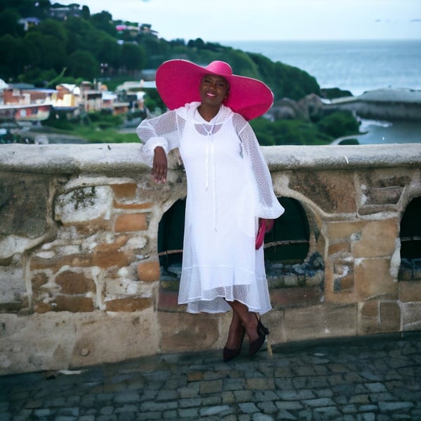 Women's Plus Size Aphrodite White Holiday Resort Dress with hoodie and white undergarment, paired with a pink sunhat.