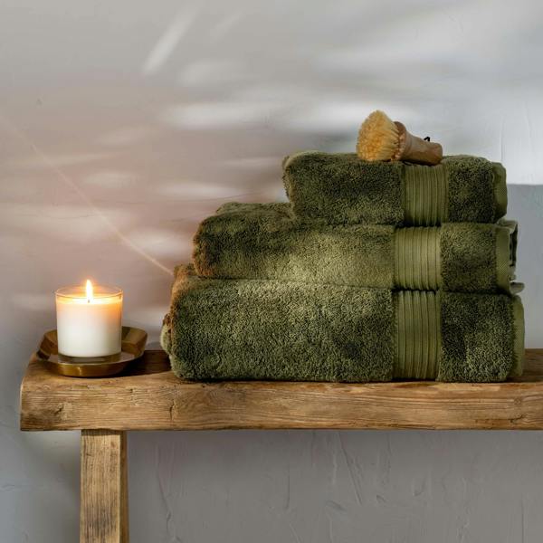 Olive Green Egyptian Cotton Bath Towels styled in a bedroom | Soak and Sleep