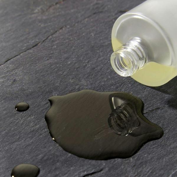 Scentered Sleep Well Body oil on a black slate from tipped over bottle 
